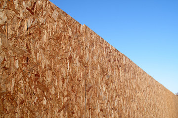 a long recycled wood bark fence.