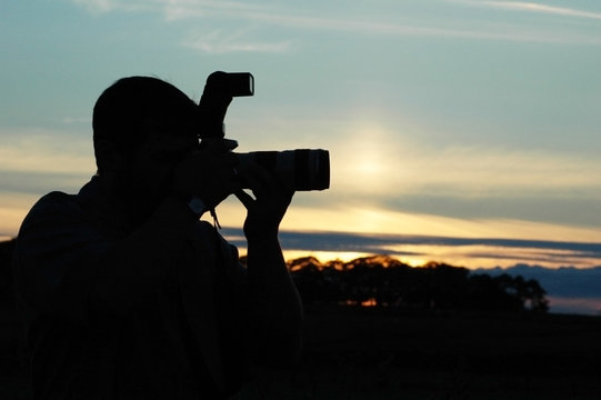 silhouette of a photographer during the sunset