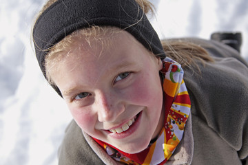 portrait of a girl with red cheeks in the snow