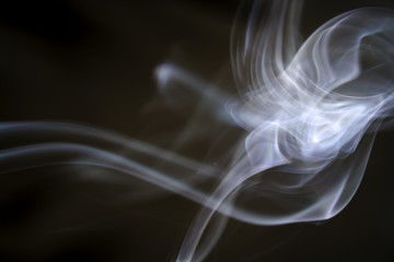 puff of aroma smoke on a dark background