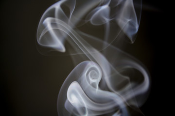 puff of aroma smoke on a dark background