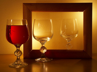glass with wine at light of candles.