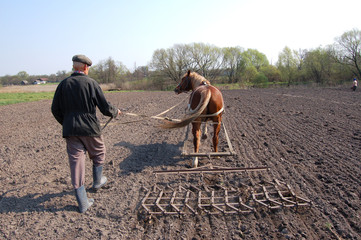 farmer at work , plowing the land