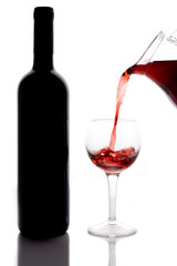 red wine pouring down from a wine pitcher