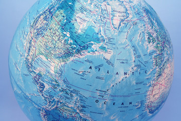 view of world globe from artic with blue background