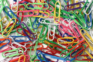 color paperclips on white background