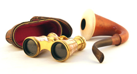 isolated antique gold binoculars with pipe and case