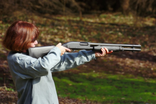 woman aiming a shotgun