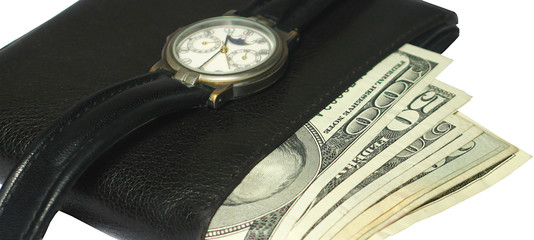 wallet full with money and a watch over close up