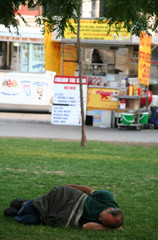 homeless man sleeping in park