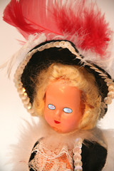 crazy scary doll with blue eyes and a black and re