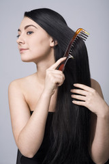 woman doing her beautiful dark hair