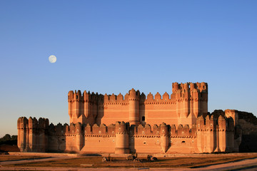 the fortress of coca (spain) at dusk with full moon © Marlee