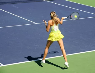 Fotobehang woman playing tennis © Galina Barskaya