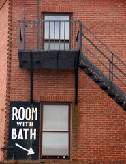 fire escape and "room with bath" sign