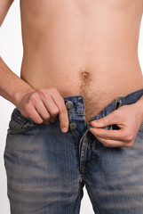 the man unbuttons trousers