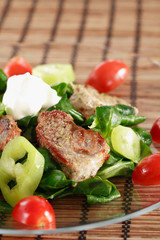 small steaks with salad and vegetable