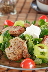 small steaks with salad and vegetable