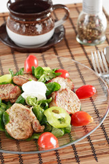 small steaks with salad and vegetable