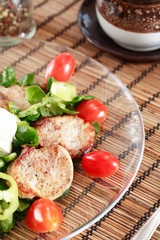 small steaks with salad and vegetable
