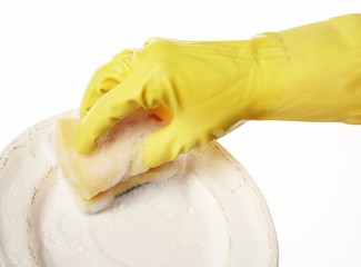 hand in yellow rubber glove with yellow sponge and