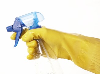 hand in yellow rubber glove with a spray