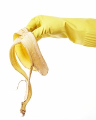 hand in yellow rubber glove with a banana peel 5
