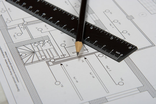 the engineering drawing on a paper. ruler. pencil.