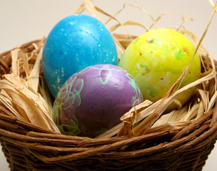 hand-painted easter eggs in a basket