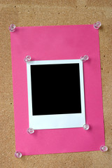 photo frame thumbtacked to cork board