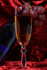 blue bottle of wine, glasses and grapes