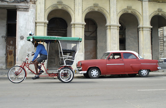 Bike Taxi And Red Taxi In Cuba