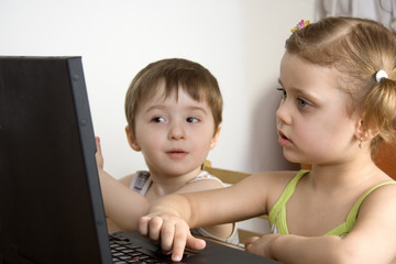 sister and brother working with a laptop