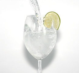 water pouring in a glass with lime