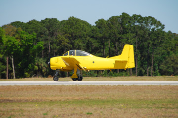 Fototapeta na wymiar vintage yellow airplane on the runway