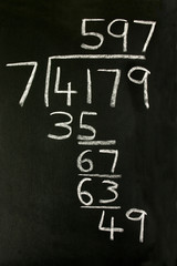 a long division sum on a blackboard.
