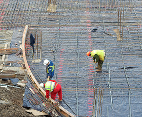 three builders on a construction site