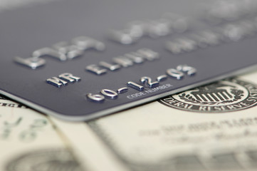 credit card and dollars with shallow depth of fiel