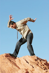 Obraz premium businessman on red rocks