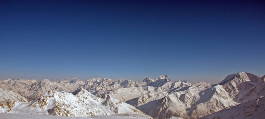 panoramic view of snow mountains.