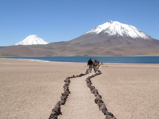 group trekking towards volcanos
