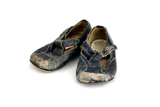 girl's old baby shoes isolated