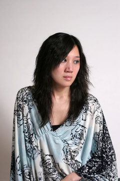 chinese woman in blue looking right