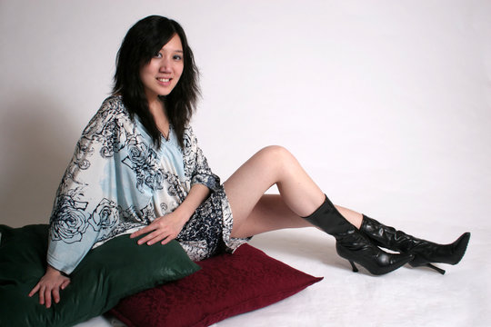 chinese woman sitting with pillows