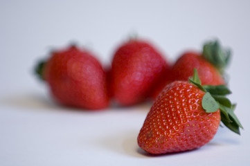 single stawberry in focus and three out of focus