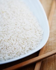 raw white rice on white plate with chopsticks  mac