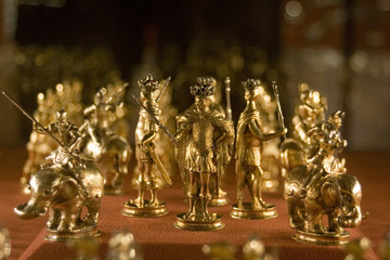 old chess pieces of gold