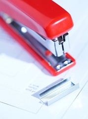 red stapler with a bunch of staples macro 5