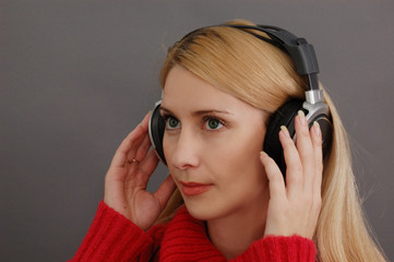 blonde woman with headphones in red