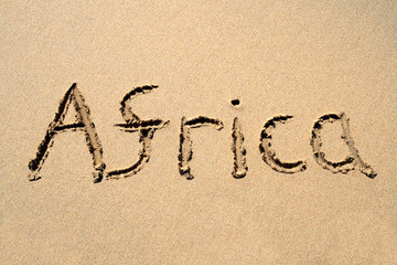 africa, written on a sandy beach.